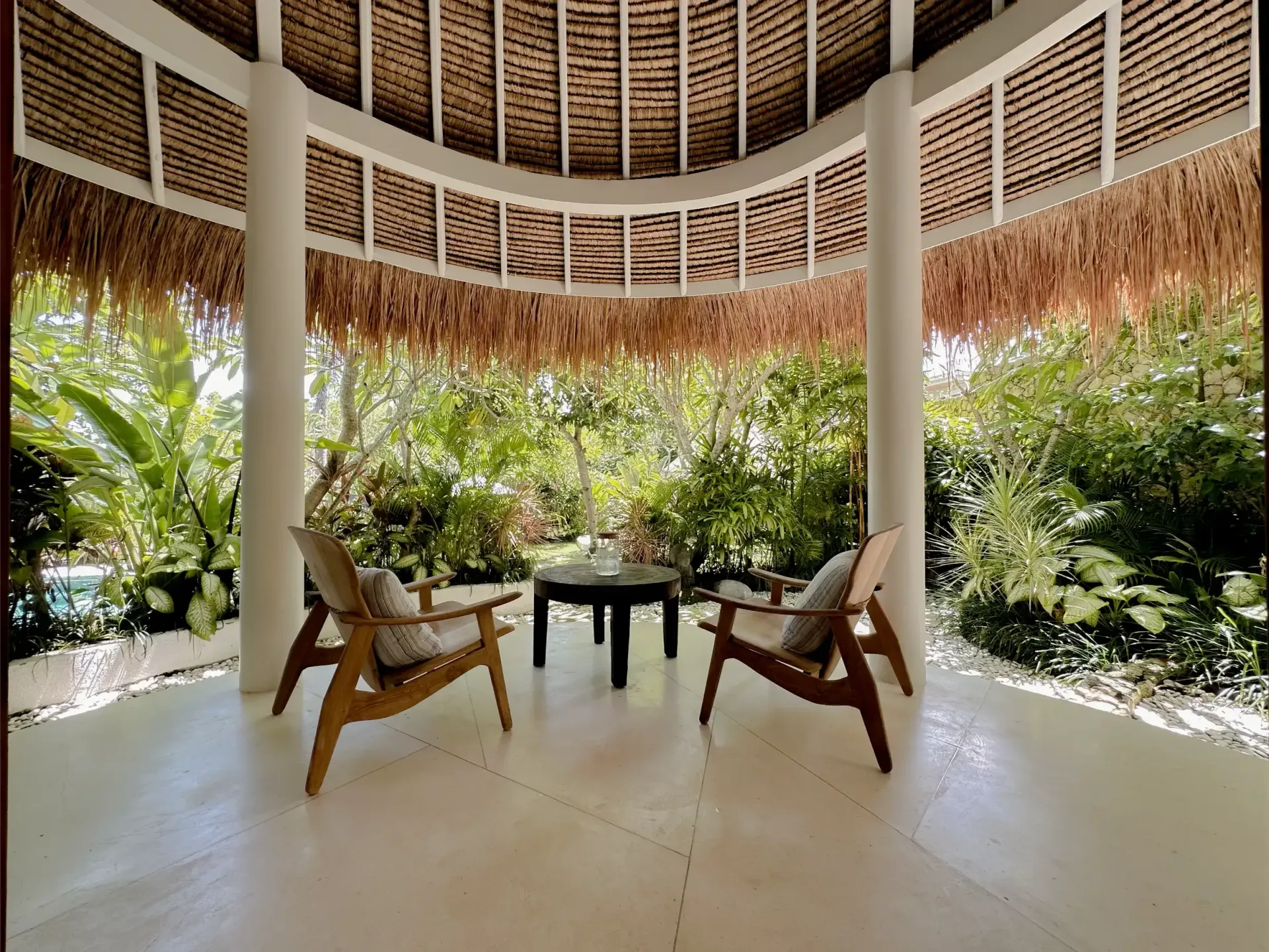 Covered villa terrace facing a lush garden
