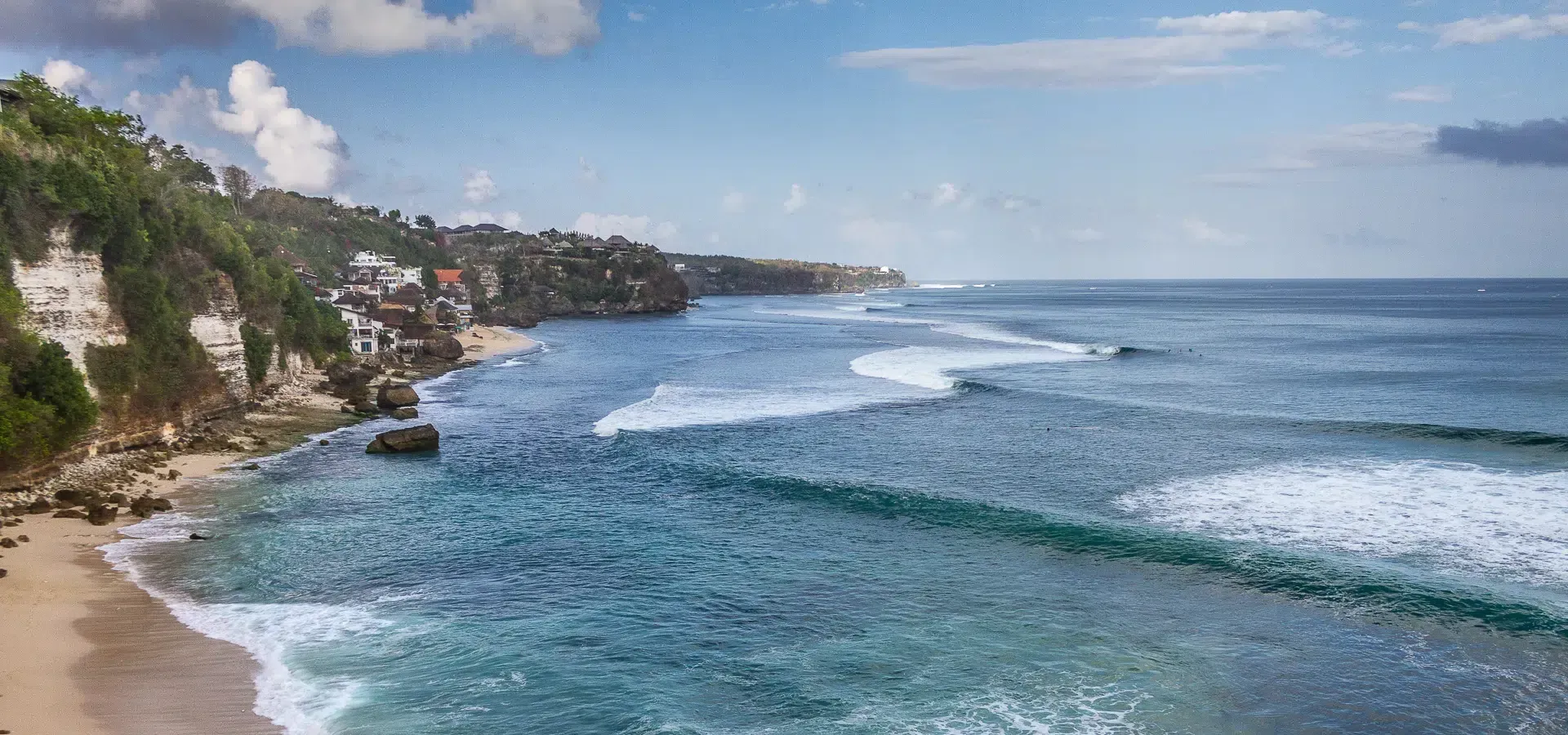 Surfer riding a wave near Bingin